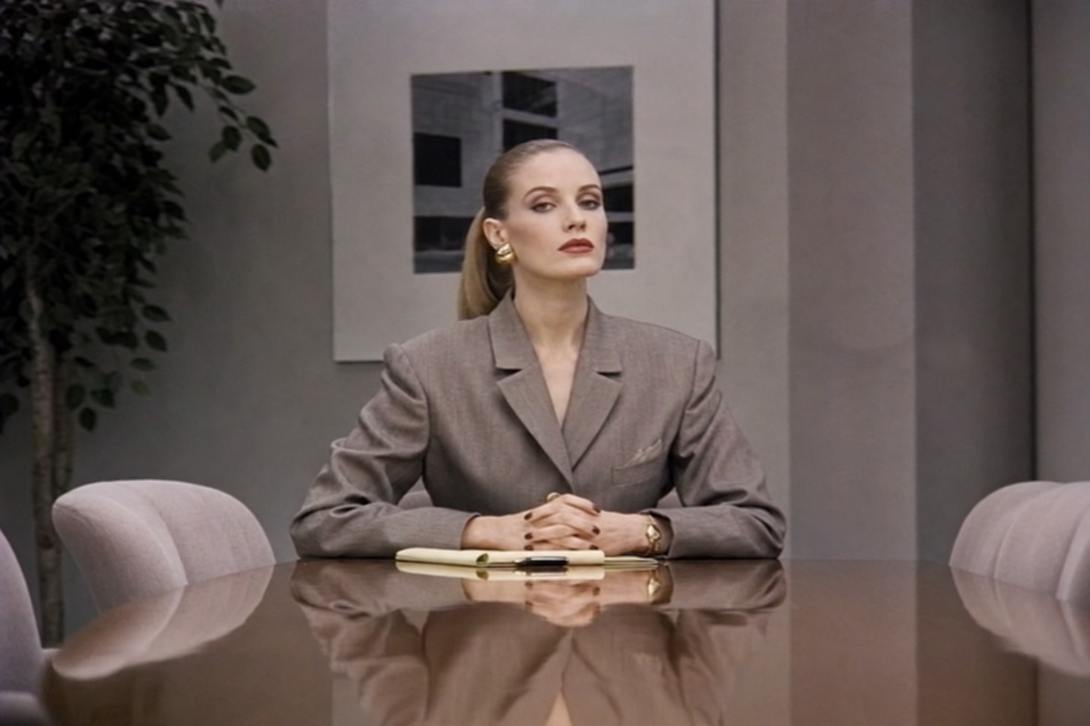 A representative of management seated at the boardroom table, awaiting your enrollment.